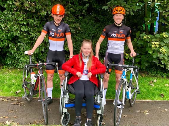 Noah (left) with his sister Evie and fellow cyclist Matthew (right)....