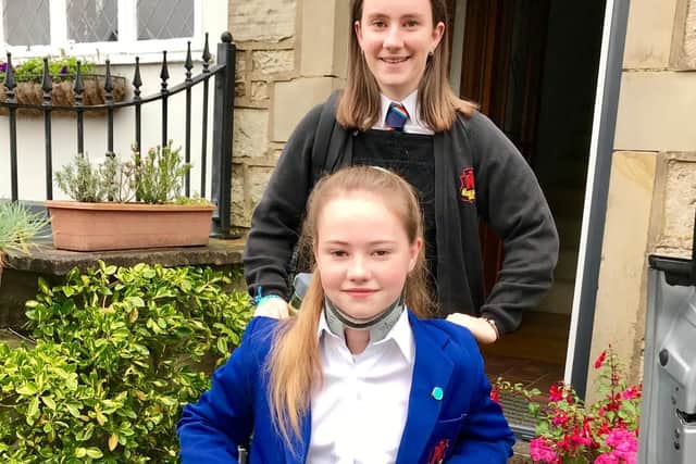 Evie returning to school with the help of her sister, Lily, also a student at Clitheroe Royal Grammar School (Sixth Form)