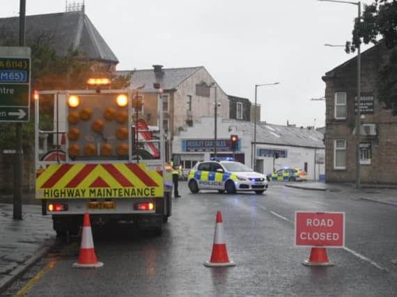 The scene yesterday in Todmorden Road, close to Burnley Cricket Club, where bomb disposal officers were called in to deal with a 'suspicious' package.
