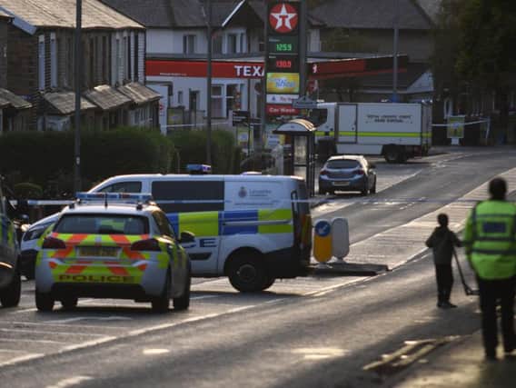 The dramatic scene last night close to the Texaco petrol station in Burnley Road, Padiham, where a suspicious device was found attached to a cash dispensing machine.