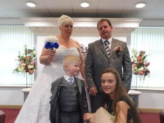 Tracey and Stephen on their wedding day with Lewis and Tracey's daughter Jade.