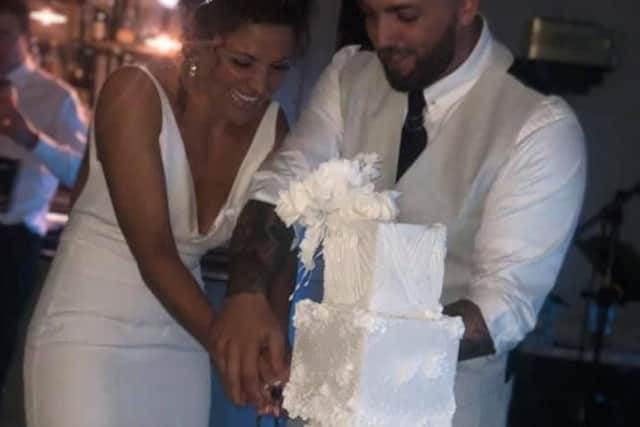 The happy couple cut their wedding cake.