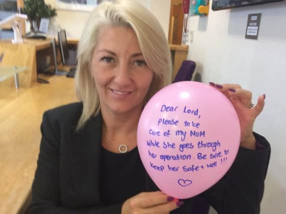 Candy Powell with the pink balloon with the heartfelt message written on it.