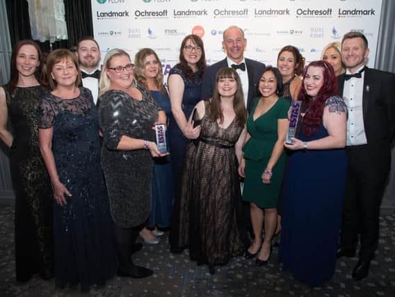 The team from Alexander Grace Law are thrilled receive their awards from TV personality Phil Spencer.
