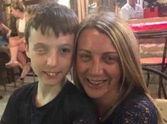 Nicola Sayers with her son, Tyler, who was hit in the face with a firework three years ago.