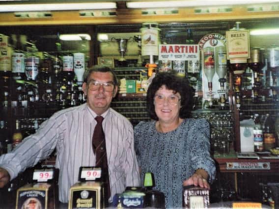 Eddie Fletcher and his wife Renee behind the bar at Rosegrove Unity Social Club in Burnley.