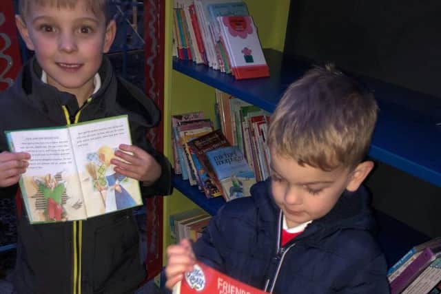 Theo Slater (six) and his brother Olly, who is four, were among some of the first borrowers at the little library.