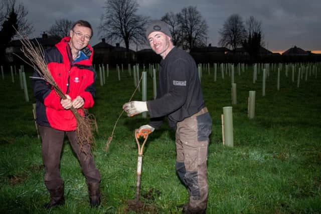 Phil Dykes from Woodland Trust with Richard Atton from Bowland Treecraft Ltd as they plant the new trees