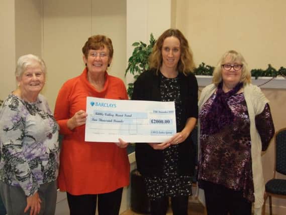 Big-hearted members of St Michael and St John's Church Ladies Group present cheque to Dr Lucy Astle