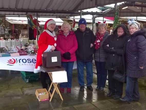 Rosemere Cancer Foundations East Lancs fundraising co-ordinator
Louise Grant (first left) welcomes shoppers and volunteers to the charitys
Clitheroe Market stall