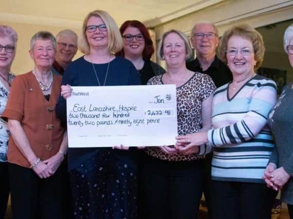 Fun-raisers hand over cheque to the hospice