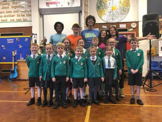 Presenter Andy Day, the Odd Socks band and pupils from the school