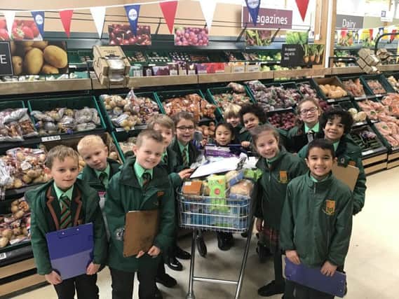 Pupils fill the shopping trolley to feed the homeless