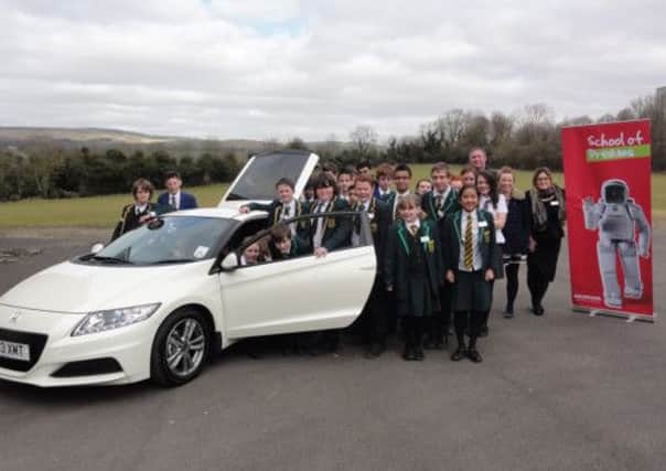 Children at Moorland School, Clitheroe, enjoy a visit from the Honda 'School of Dreams' team.