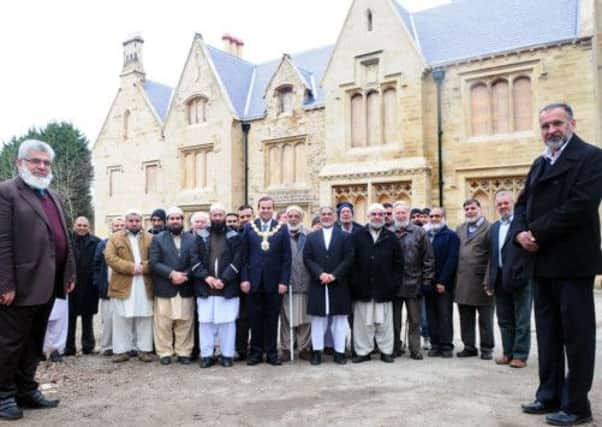 The Mayor of Pendle (centre) along with Mohammed Afzal president of the Nelson branch of the UK Islamic Commission (left) and Abdul Haq Mian president of the UK Islamic Commission and others visiting Spring Bank Cottage in Nelson which is being restored.
Photo Ben Parsons