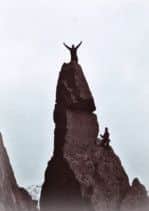 TRIUMPH: Arms aloft, Mr Peel conquering Napes Needle the day before he died.