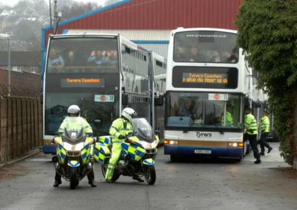 Burnley fans queue to board the buses at Turf Moor ahead of their clash with Blackburn Rovers at Ewood Park.