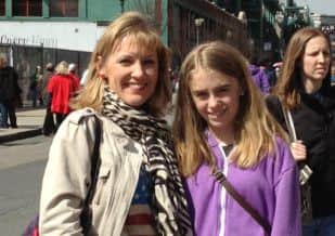 DEVASTATED: Nicola Nuttall and her daughter Laura just before the terrifying explosions in Boston on Monday afternoon (S)