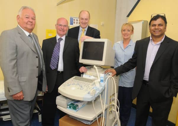 Chair of East Lancs Prostrate Cancer Support Group Dave Riley, Stuart Marshall (secretary), Burnley MP Gordon Birtwistle, Tracy Cooke (clinical nurse specialist neurology) and Mr Mohan Pillai (consultant neurologist) with the old scanner.