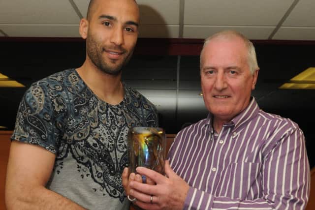 Lee Grant receives his player of the year award from Chris Wells.