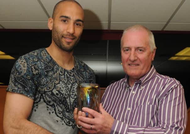 Lee Grant receives his player of the year award from Chris Wells.