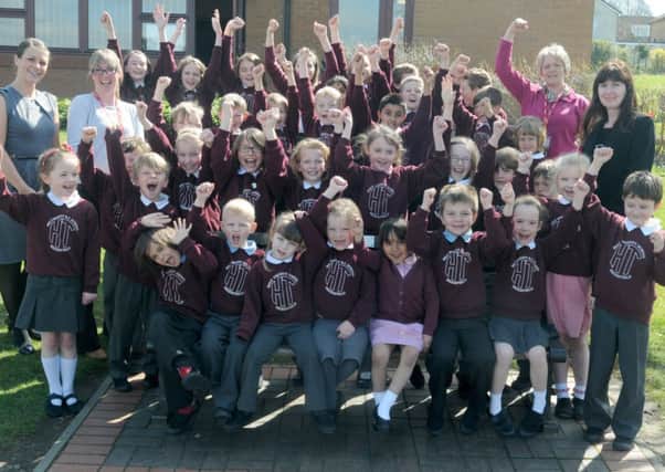 Holy Trinity RC Primary School pupils celebrate their Ofsted report.