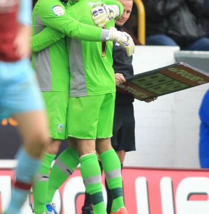 Brian Jensen hugs Lee Grant as he makes his late appearance from the bench.