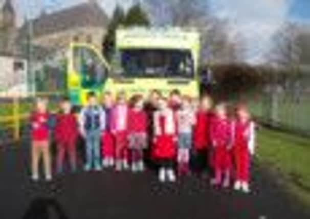 Mark Evans shows his ambulance to children at St Michael and John's RC Primary School as part of a coffee morning event to raise funds for the school's community defibrillator appeal. (s)