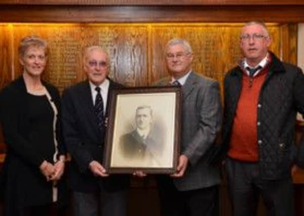 Mr Jeffrey Pomfret presents a framed photograph of his grandfather, former Burnley secretary/manager Spencer Spen Whittaker, to Clarets Historian Ray Simpson.