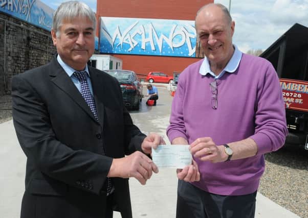 SCANNER APPEAL: Wash Worx co-owner Ian Wilson presents Gordon Birtwistle MP with a cheque for £500 for his scanner appeal.