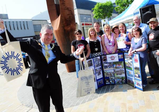 The Deputy Mayor of Pendle Coun. Graham Roach officially opens the Volunteers Week event in Nelson Town Centre.
Photo Ben Parsons
