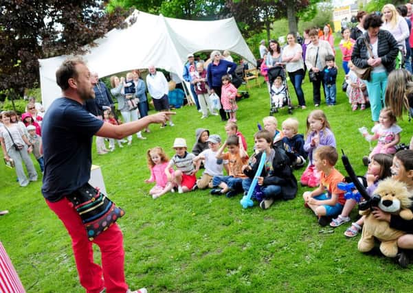 Children enjoy the magic show at Valley Gardens summer fair in Barnoldswick.
Photo Ben Parsons