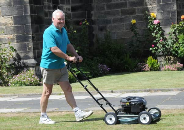 Gardener Bob Wilson seen mowing the lawn.