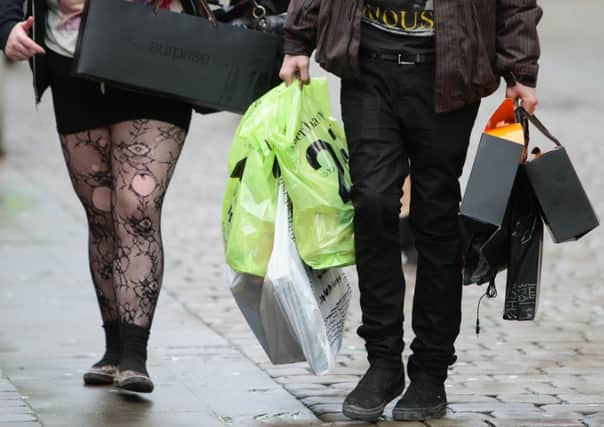 Shoppers carrying their bags. Photo: Dave Thompson/PA Wire