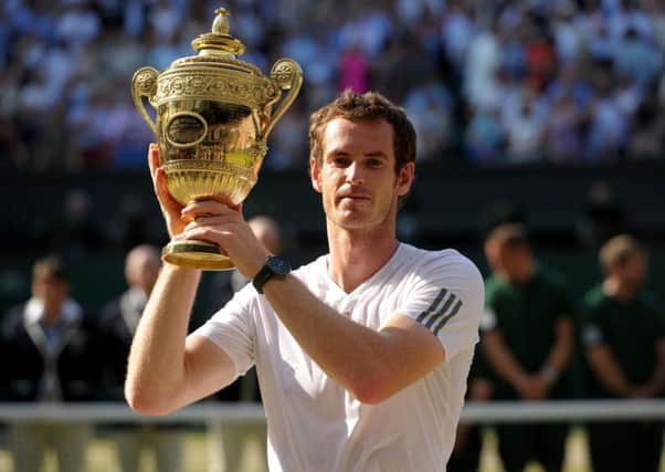 AT LAST!: Andy Murray holds aloft the Wimbledon mens singles trophy