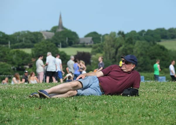 A village festival goer soaks up the sun at the bottom of Parbold Hill