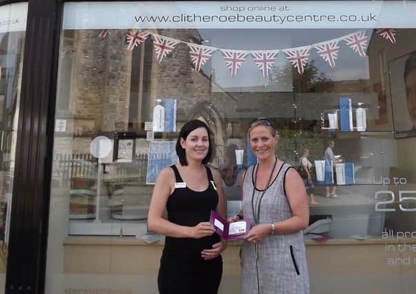Sarah OCallaghan (left) gives Claire her vouchers at Clitheroe Beauty Centre. Photo: Andrew Hale Photography.