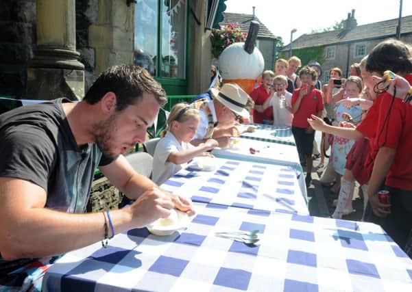 Clitheroe Advertiser's Dan Black joins in with the 'brain freeze' competition at the 100th anniversary celebrations at Hudson's Ices.