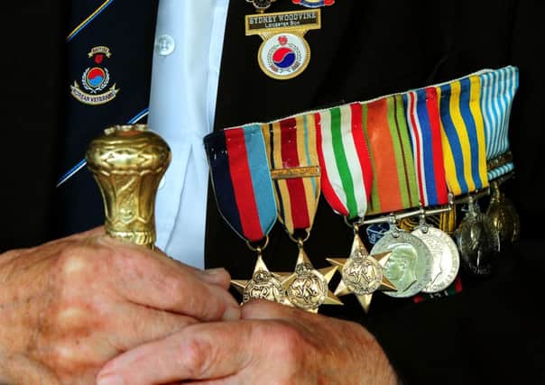 Syd Woodvine, 91, a Korean war veteran shows of his decorations during a special ceremony to mark the 60th  anniversary of the conflict. Photo: Rui Vieira/PA Wire