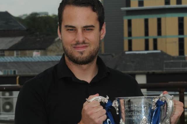 CUP MAGIC: Dan Black shows off the Capital One Cup at the Burnley Express office on Thursday