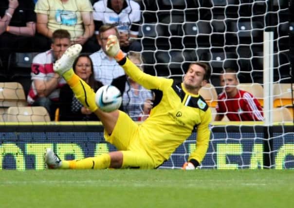 BIG MOMENT: Tom Heaton saves Johnny Russells penalty kick with the Clarets 2-0 up at Derby on Saturday