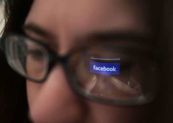 Using Facebook on a smartphone. Photo: Yui Mok/PA Wire