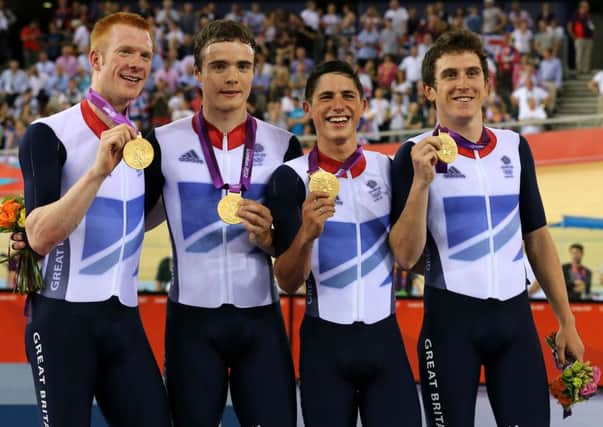 Great Britain's Ed Clancy (left), Geraint Thomas (right), Steven Burke (second left) and Peter Kennaugh celebrate with their Gold medals in the Men's Team Pursuit Final during day seven of the Olympic Games at the Velodrome, London. Photo: Andrew Milligan/PA Wire.