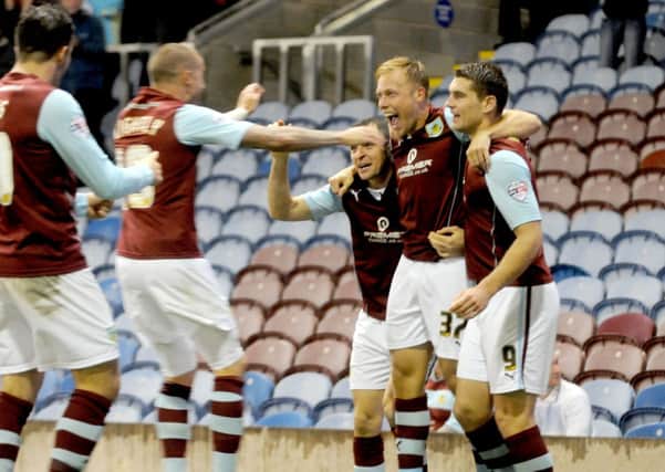 Get in!: Burnley players celebrate with Scott Arfield after his goal against Birmingham City on Tuesday night