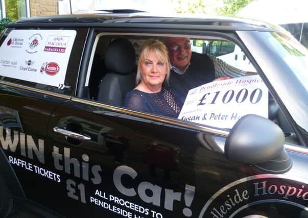 Winner of the Pendleside Hospice car raffle Susan Hornsey and her husband Peter
