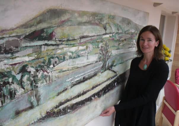 Clitheroe artis Angela Baptie with the painting which she has donated to East Lancashire Hospice