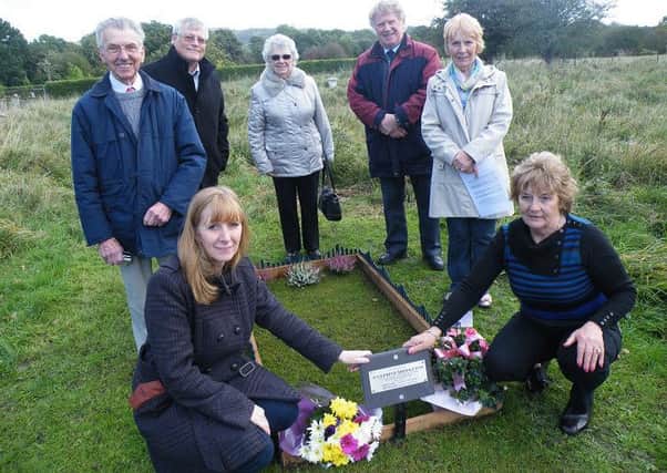 Sandra McArdle kneels at the grave side with her niece Christine Harrison with, from left to right in the background, George Hardman, Mel Diack MBE, Ida Hardman, Cliff Ball, Minneka Milne, Sandra's sister. (s)