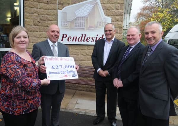 Kaye Bartle is presented with a cheque for £27,000 by Stephen Alderson, Chris Gribben, John Horan and Paul Thornton
