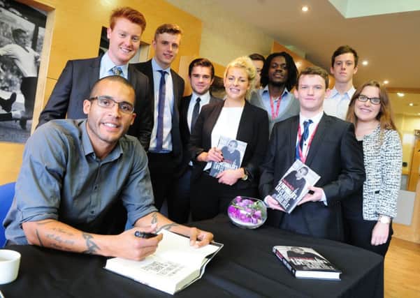 Clarke Carlisle signs copies of his book at UCFB in Burnley. Photo Ben Parsons