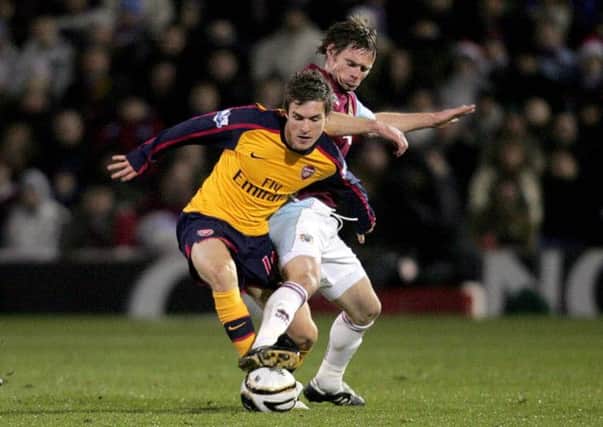 Arsenal's Aaron Ramsey (left) fouls Burnley's Graham Alexander as they battle for the ball during the Carling Cup Quarter Final match at Turf Moor, Burnley. PRESS ASSOCIATION Photo. Picture date: Tuesday December 2, 2008. See PA story SOCCER Burnley. Photo credit should read: Martin Rickett/PA Wire. RESTRICTIONS: Use subject to restrictions. Editorial print use only except with prior written approval. New media use requires licence from Football DataCo Ltd. Call +44 (0)1158 447447 or see www.paphotos.com/info/ for full restrictions and further information.